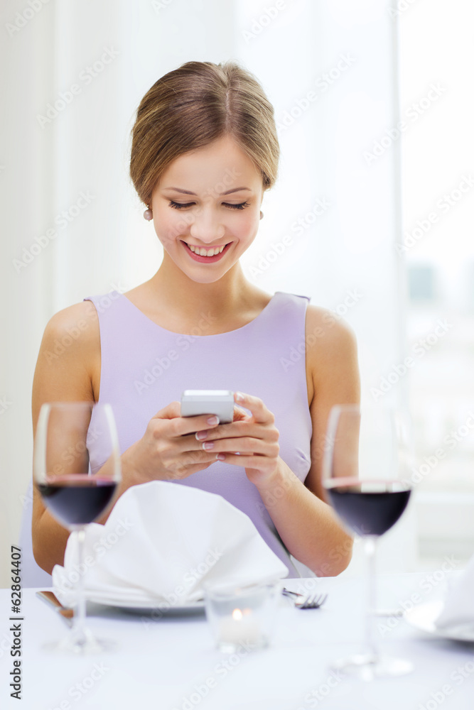 smiling woman with smartphone at resturant smiling woman with smartphone at resturant