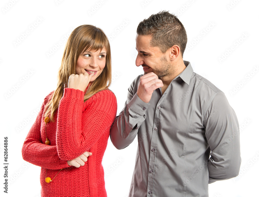 Couple looking at each other over white background Couple looking at each other over white background