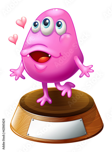 A pink beanie monster standing above the trophy stand