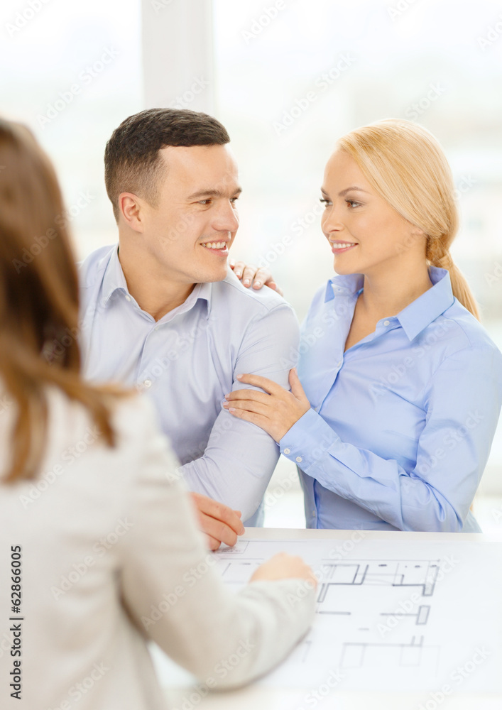 Fototapeta premium smiling couple looking at blueprint