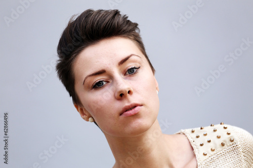 Beautiful girl face on a grey background