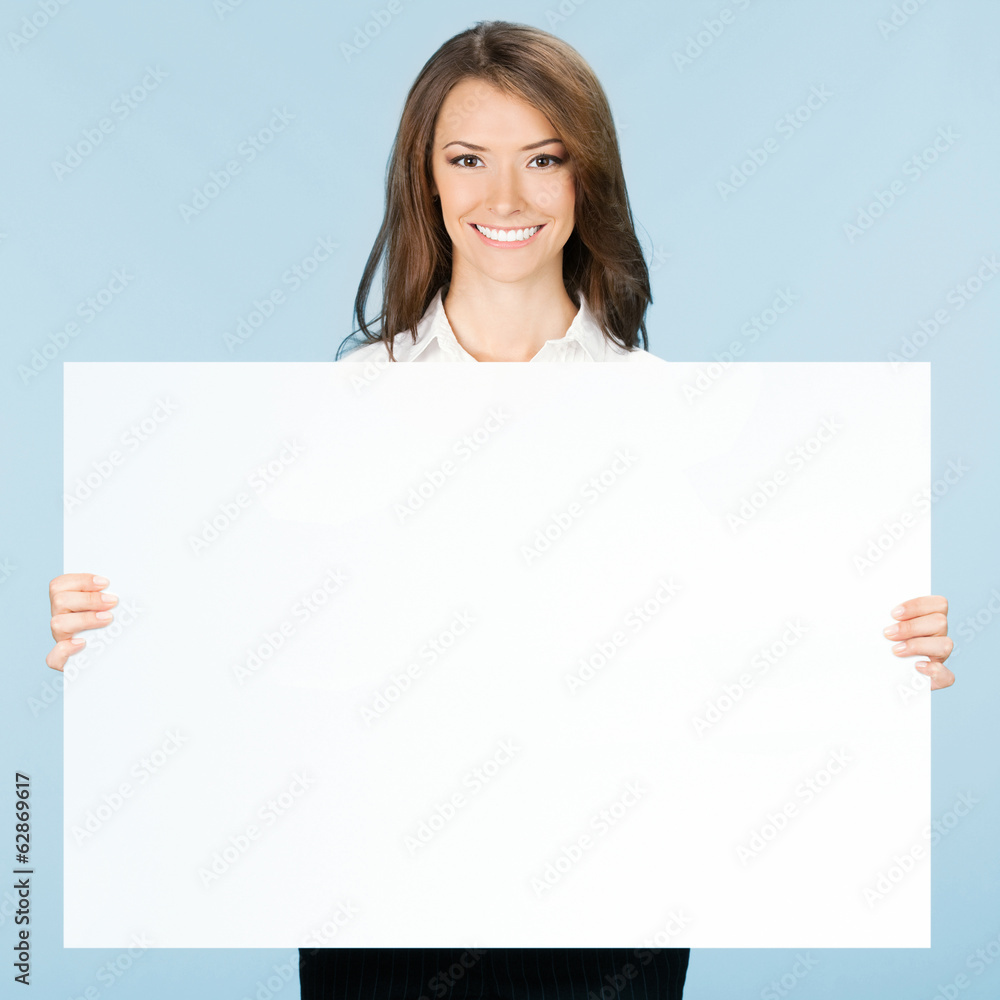 Businesswoman showing signboard, over blue Businesswoman showing signboard, over blue
