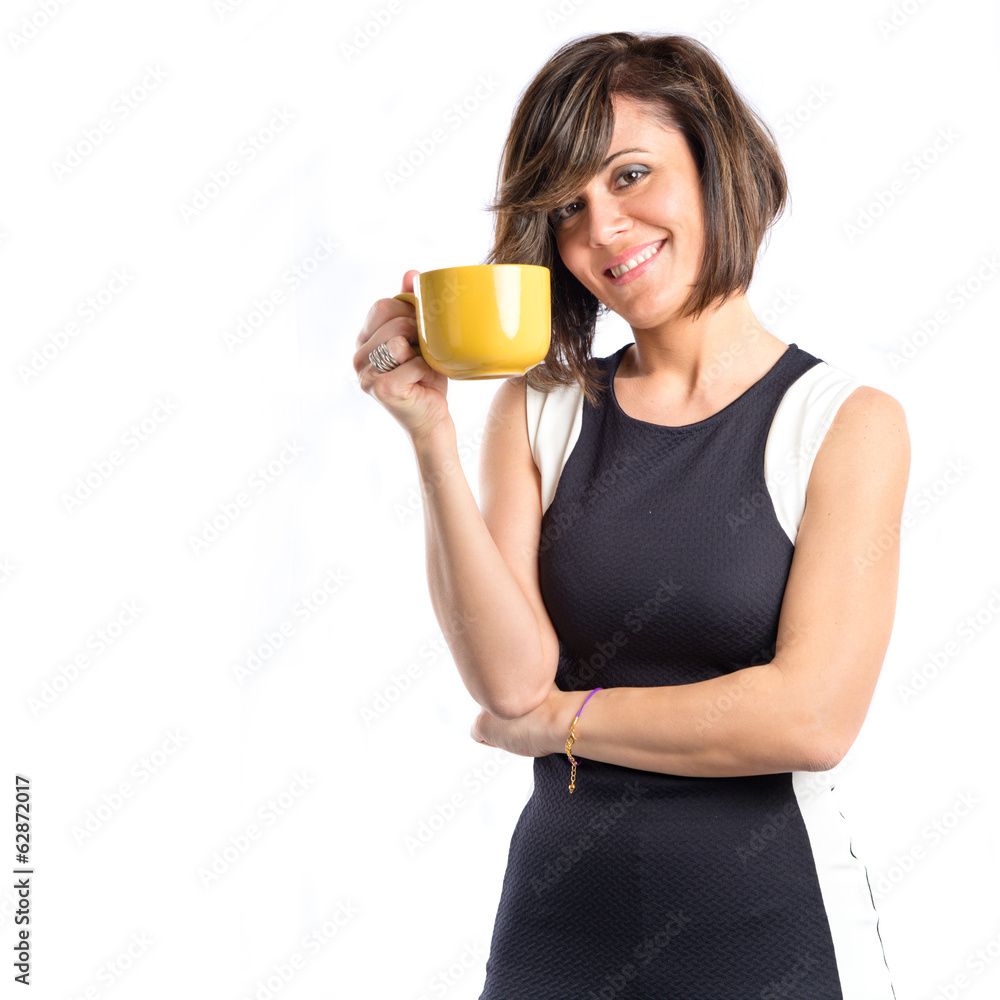 Pretty girl holding a cup of coffee over white background Pretty girl holding a cup of coffee over white background