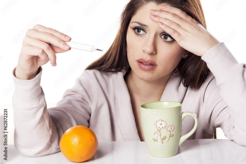 beautiful woman with fever watching the thermometer beautiful woman with fever watching the thermometer