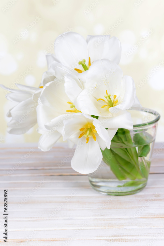 Beautiful bouquet of white tulips on table on light background Beautiful bouquet of white tulips on table on light background