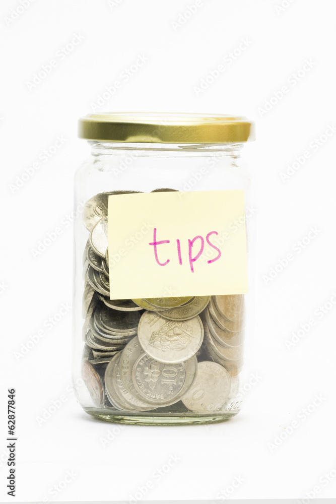 Isolated coins in jar with tips label - financial or business co Isolated coins in jar with tips label - financial or business co
