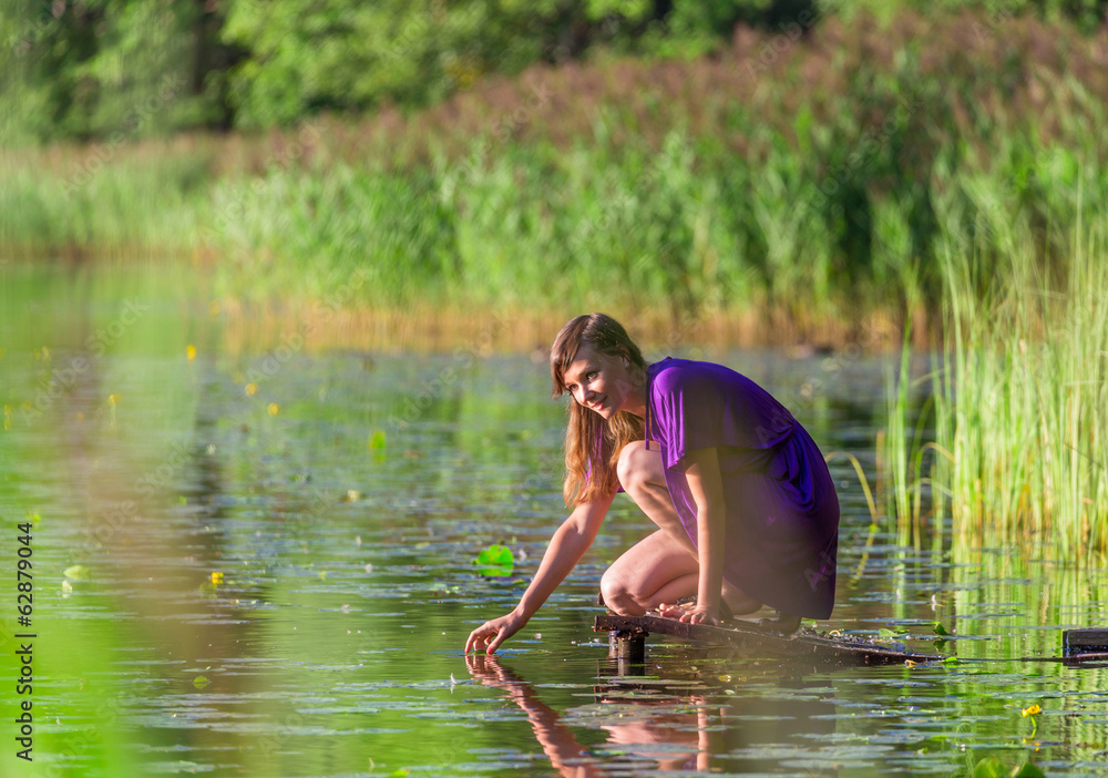 Young woman ralax near lake Young woman ralax near lake
