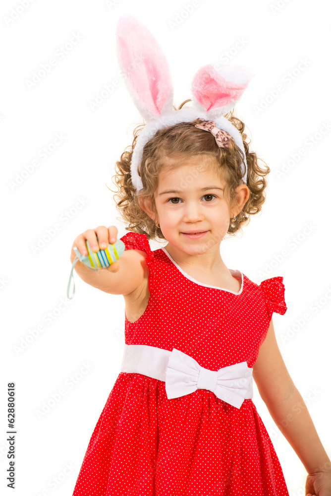 Small girl with bunny ears giving Easter egg Small girl with bunny ears giving Easter egg