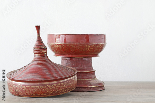 Antique red lacquer wares on wooden table white background (Stil photo