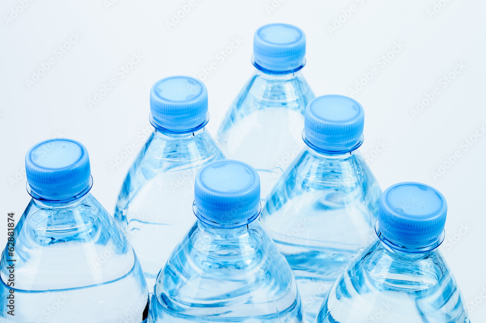 Six water bottles with blue caps Six water bottles with blue caps