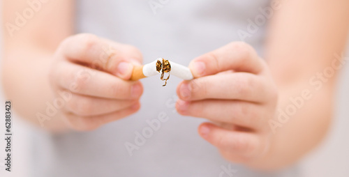 Young girl is breaking a cigarette