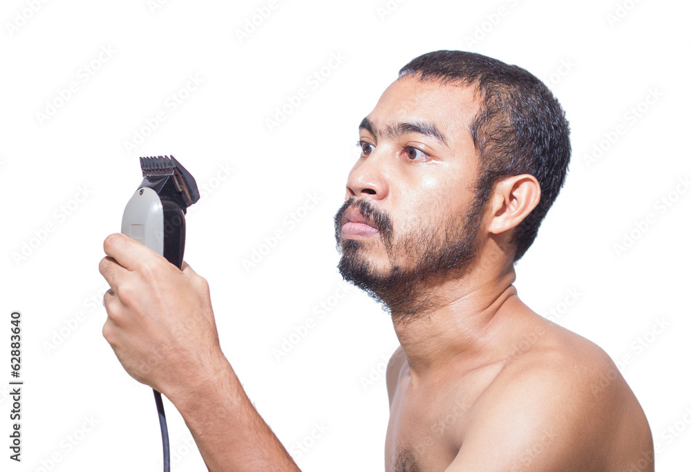 Naklejka premium Asian man seriously hold hair clipper