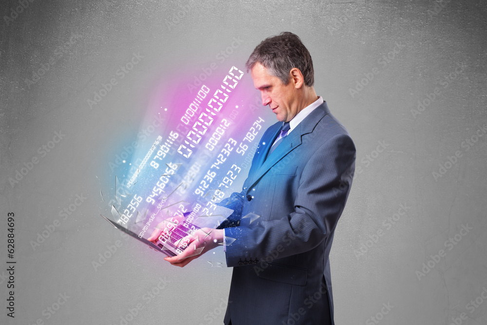 Businessman holding notebook with exploding data and numbers