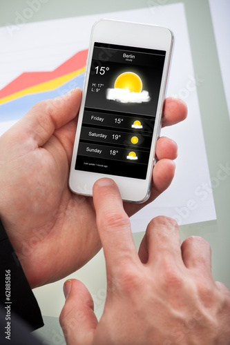 Wallpaper Mural Man checking the weather forecast for the day Torontodigital.ca