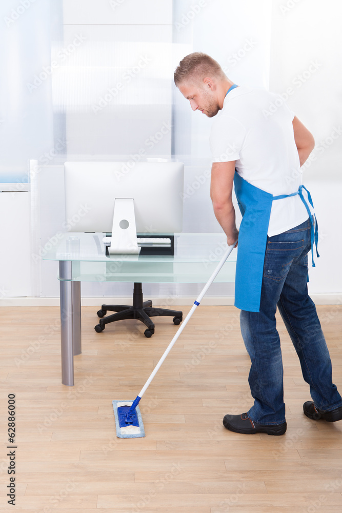 Janitor cleaning the floor in an office building