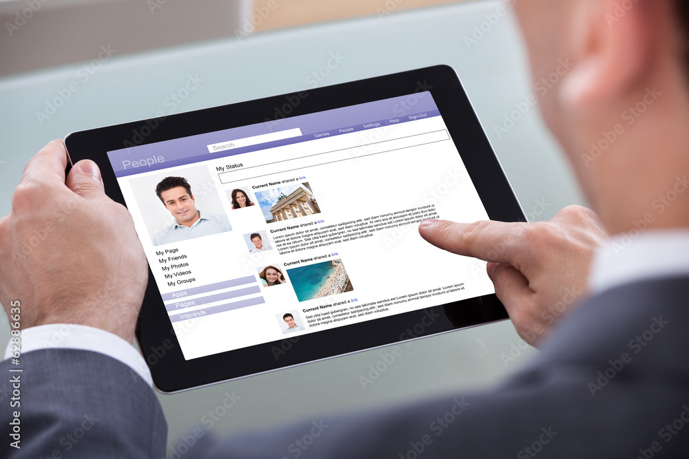 Fototapeta premium Close-up Of Man Browsing On Digital Tablet