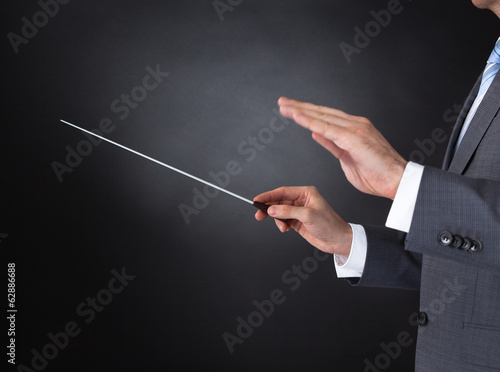 Orchestra Conductor Holding Baton
