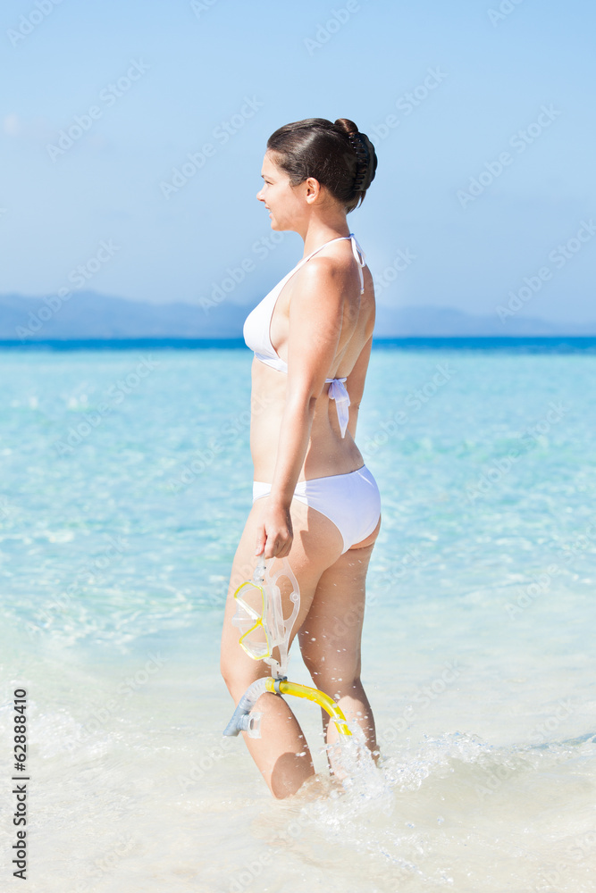 Fototapeta premium Woman Holding Snorkel While Standing In Sea