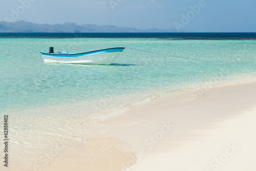 Boat moored in sea at beach