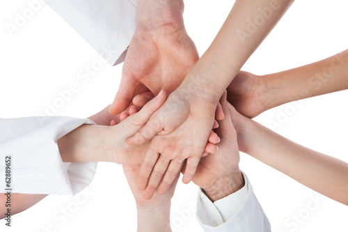 Doctors and nurses stacking hands