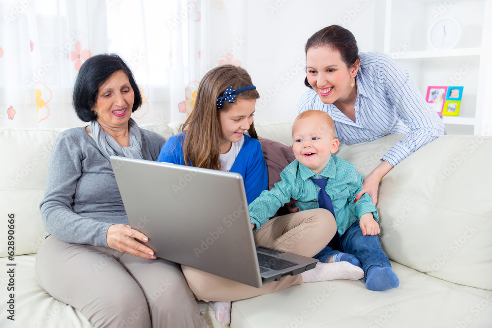 Grandmother, mother, daughter and son using laptop at home. Grandmother, mother, daughter and son using laptop at home.