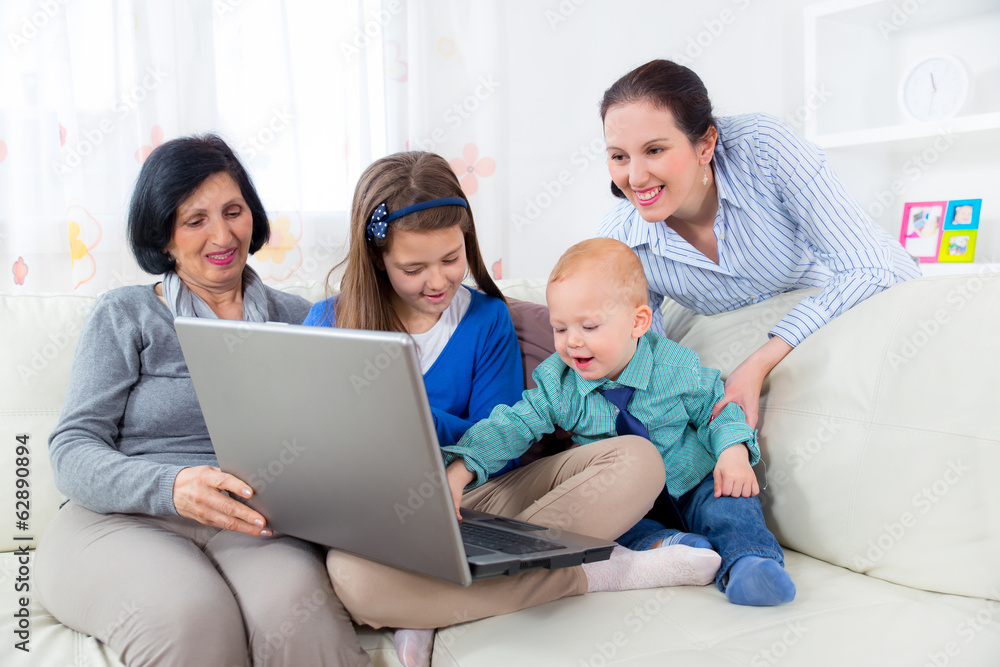 Grandmother, mother, daughter and son using laptop at home. Grandmother, mother, daughter and son using laptop at home.