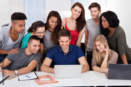 University Students Using Laptop Together