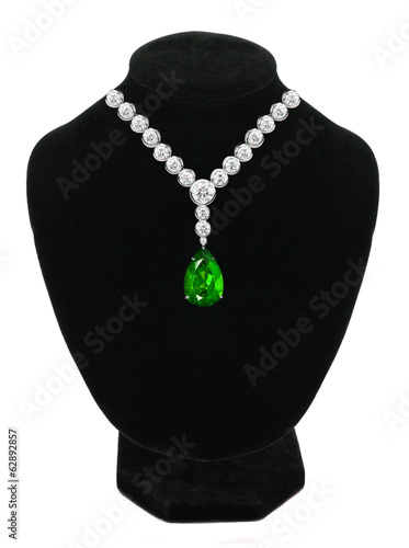 Diamond and emerald necklace on black mannequin isolated on whit