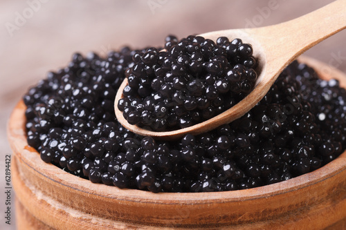 Spoon with black sturgeon caviar macro.