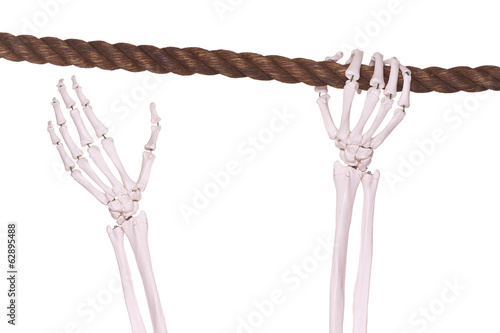 skeleton hand with old brown rope