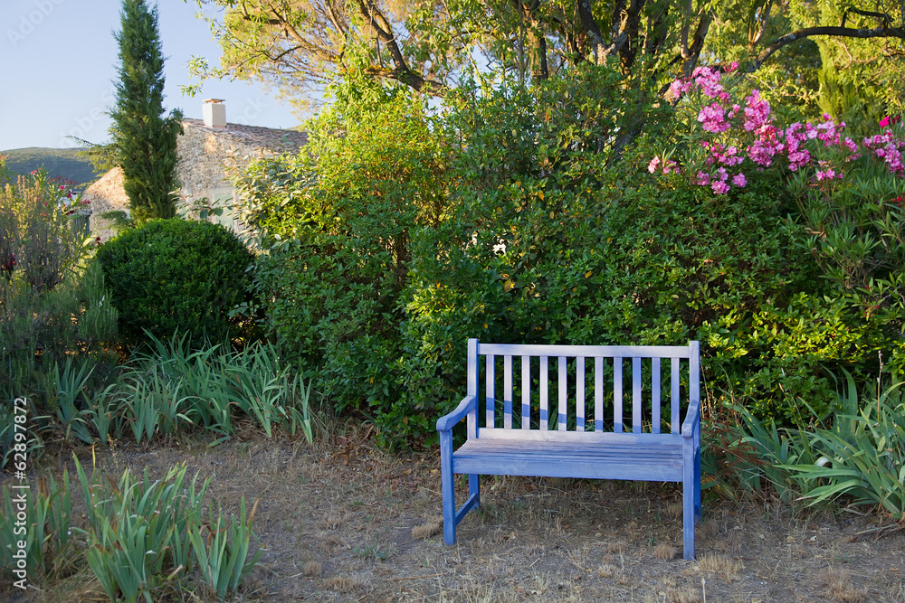 Fototapeta premium Blue painted wooden garden bench, Provence, France.