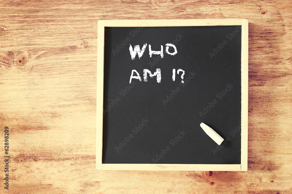 who am i concept written over chalkboard  