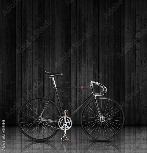 Classic fixed gear bicycle on black wood stage