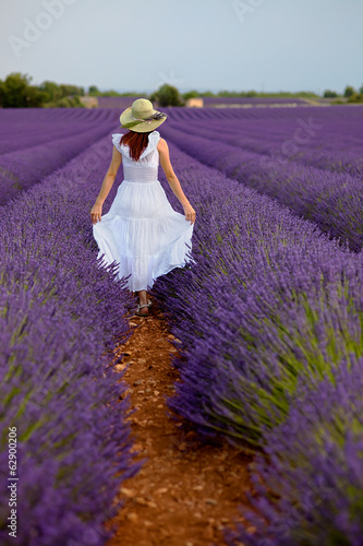 Beautiful woman in field of lavender in Provence, France.