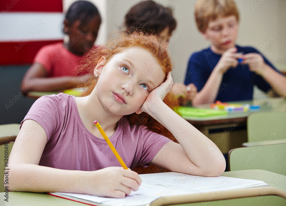 Girl in elementary school class thinking Stock Photo | Adobe Stock