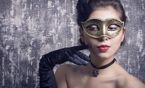 Portrait of a beautiful woman in carnival mask.