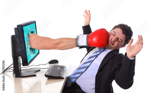 Fotografi Business man with computer hit by boxing glove in stress concept