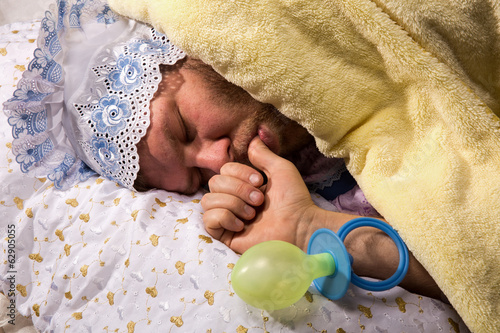 Φωτογραφία Man weared as baby sleep sucking his thumb