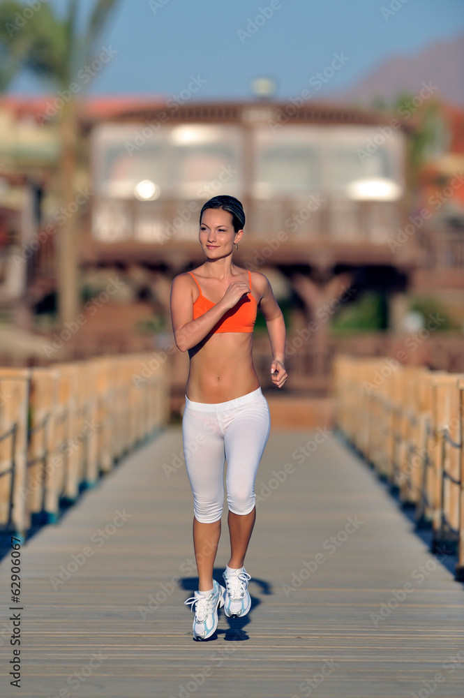 young woman jogging on the beach young woman jogging on the beach