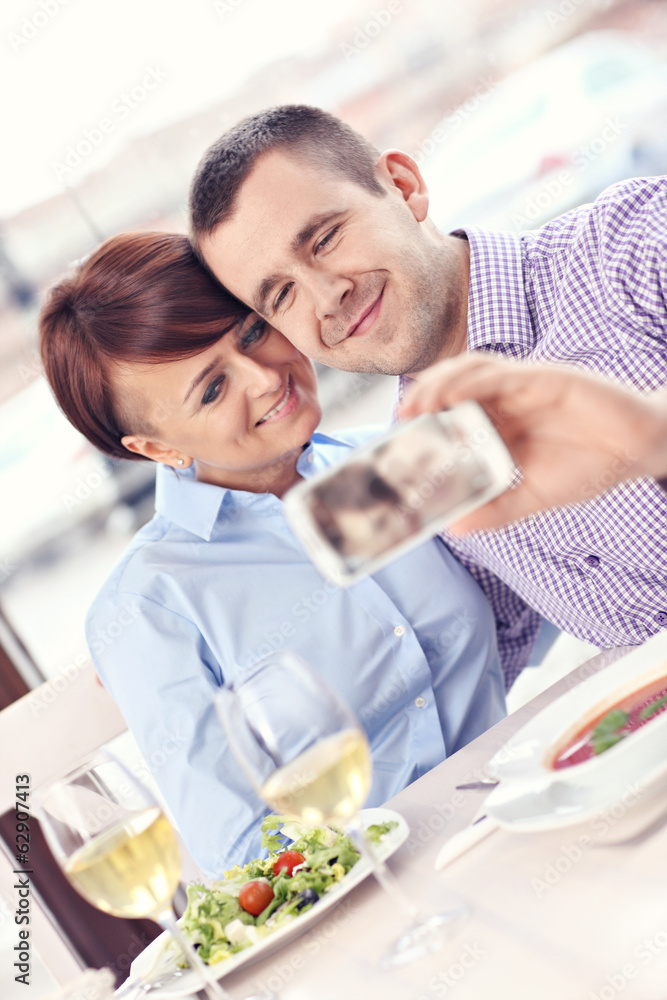 Young couple taking a picture in a restaurant
