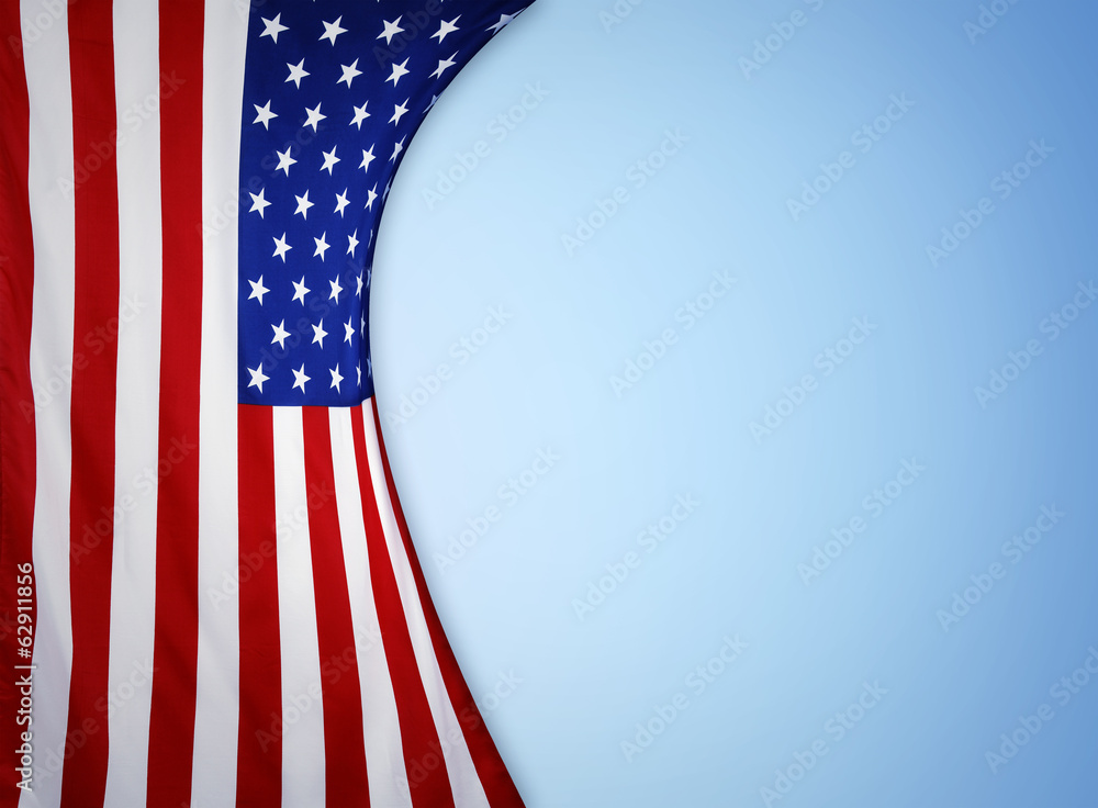Fototapeta premium American flag on blue background. Advertising copy space
