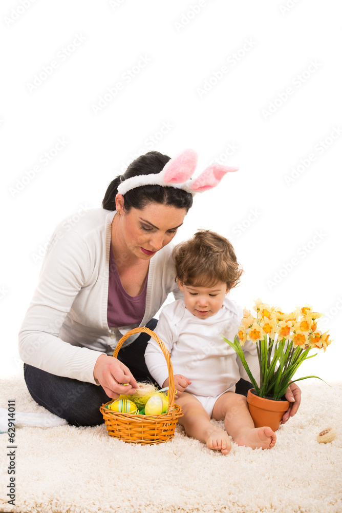 Mother and son arrange Easter basket - obrazy, fototapety, plakaty 