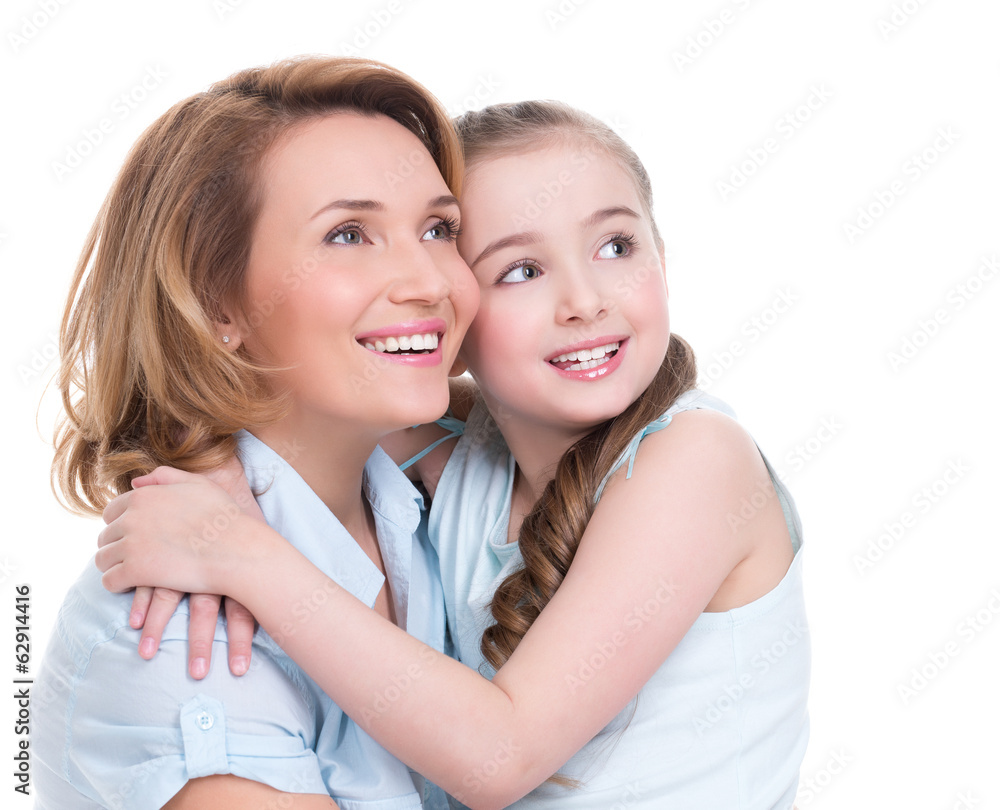 Smiling mother and young daughter looking up Smiling mother and young daughter looking up
