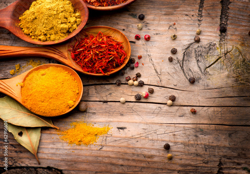 Spices and herbs. Curry, saffron, turmeric, cinnamon over wood