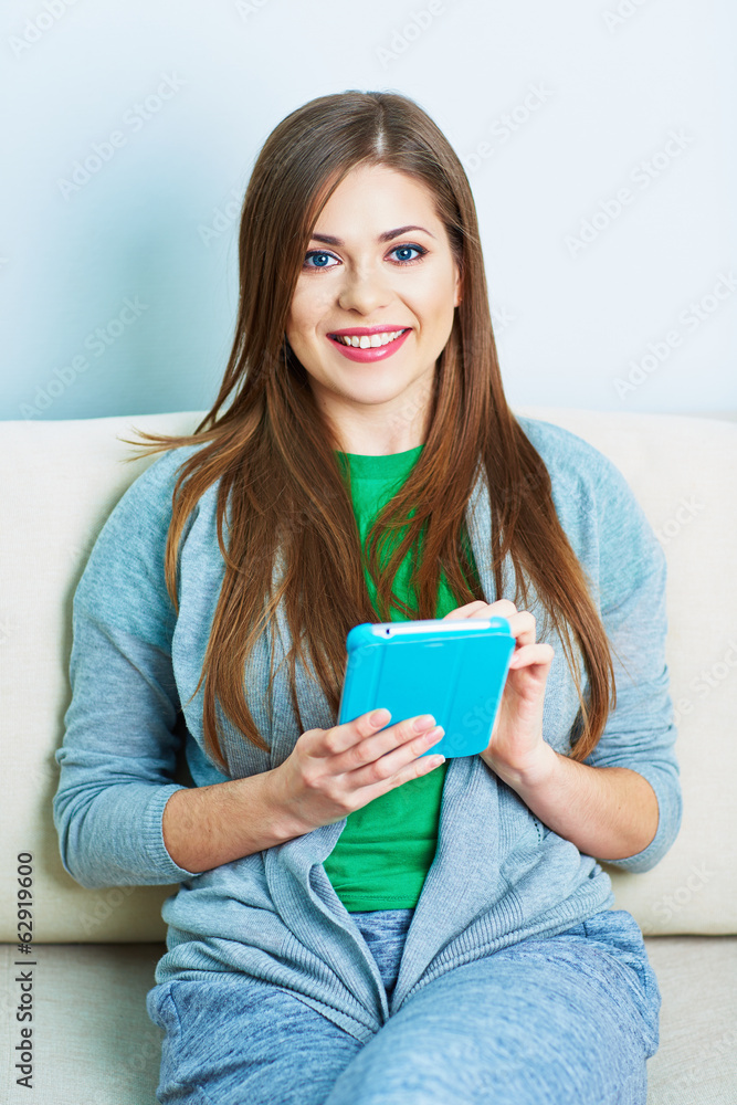 Smiling woman on sofa with tablet pc. Young smiling model Smiling woman on sofa with tablet pc. Young smiling model