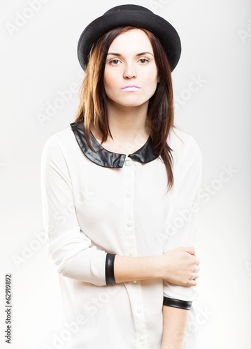 Fashion portrait of young woman in hat