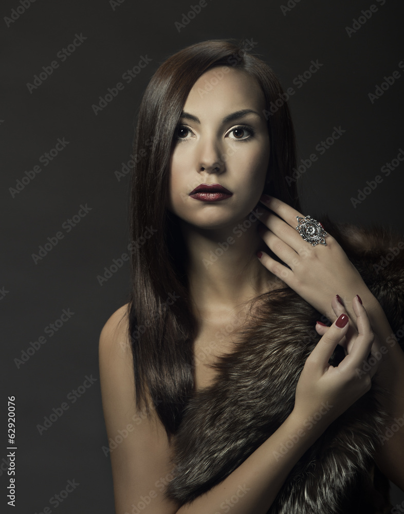 Fototapeta premium Woman beauty portrait in luxury fur coat. Beautiful girl on dark