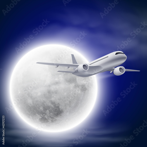 Airplane in the night sky with moon.