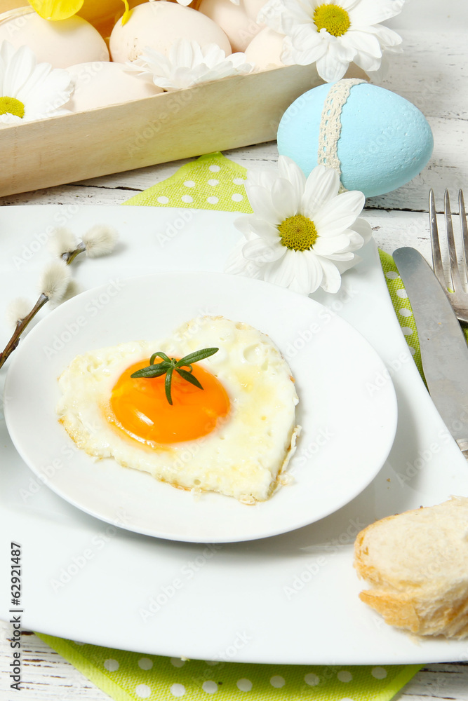 Easter table setting with flowers and eggs on old wooden table Easter table setting with flowers and eggs on old wooden table