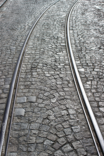 Old cobblestone street with rails